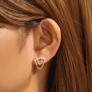 Macro view of 925 sterling silver screw back stud earring with tassel chains on ear