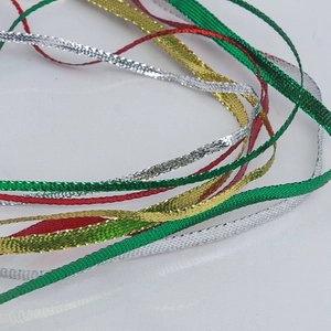 Close-up of metallic woven ribbons in red, green, gold, and silver for gift wrapping