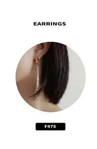 Detail view of gold knot tassel earrings with sparkling white cubic zirconia rows