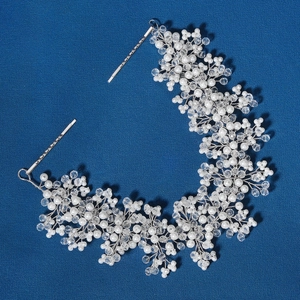 Handmade bridal headband with white faux pearls and crystal beads on a deep blue background