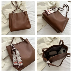 Brown tote bag with braided handles, silk scarf detail and spacious interior view
