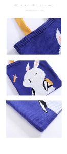 Detail view of navy blue knitted tote bag with white cartoon rabbit and yellow handles