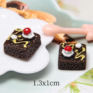 Close-up of miniature chocolate resin cakes on a lace plate for DIY crafts decoration