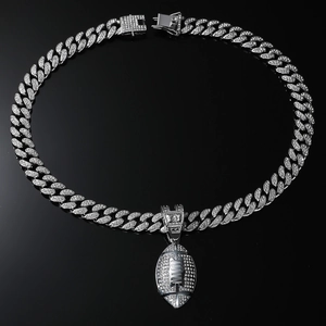 Macro detail of silver hiphop rugby pendant with sparkling crystals on cuban link chain