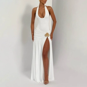 Detail of white halter neck dress featuring a golden shell-shaped buckle on the side waist