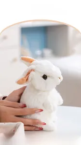 Close-up of a lifelike white plush bunny with soft ears and detailed realistic faux fur