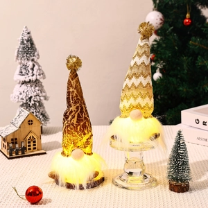Detail of light-up Christmas gnomes with leopard and wave patterns in a cozy festive scene