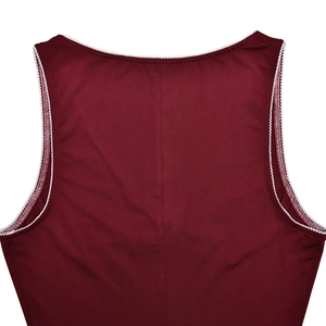 Close-up of wine red sleeveless dress back featuring white lace trim and center seam