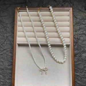 Elegant double-layer pearl necklace set with zircon bow pendant in a premium jewelry box