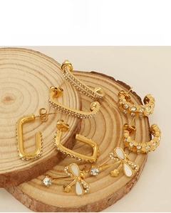 Detail of 18K gold plated stainless steel earrings on wood, lead and nickel-free