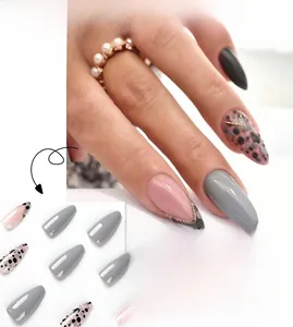 Macro detail of French press-on nails with grey leopard spots and gold metallic line trim