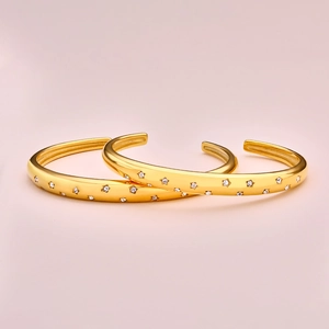 Luxury gold open bangles for women featuring star charms with shimmering crystals