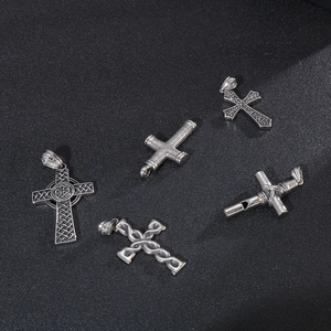 Five assorted vintage stainless steel cross pendants with Celtic and textured designs