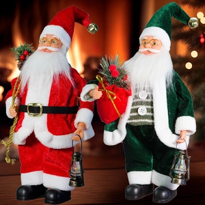 Detail of red and dark green Santa Claus and elf plush dolls with Christmas tree background