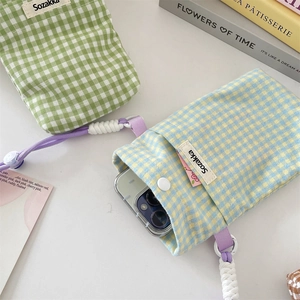 Detail of teal and light blue checkered canvas phone bags with button closure