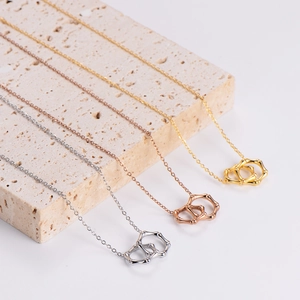 Bamboo style interlocking double ring necklace in silver, gold, and rose gold finishes