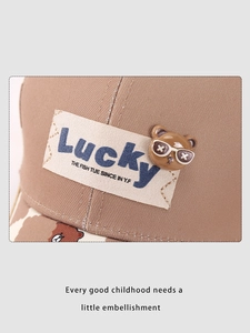Detail of children baseball cap showing Lucky patch and 3D bear charm on twill cotton
