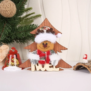 Detail of wooden Christmas tree ornament featuring a plush reindeer with Noel cutout text
