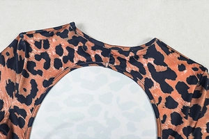 Detail of round neckline and back cutout on leopard print slim fit jumpsuit garment