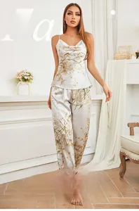 Close-up of elegant floral print pajamas set in silky cream fabric with camisole and pants