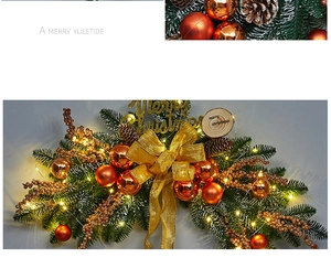Detail of Christmas wreath with champagne gold ornaments, pine cones, and warm LED lights