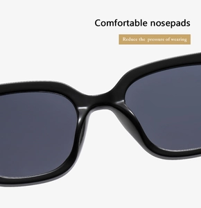 Detail of integrated comfortable nose pads on black square sunglasses frame for pressure relief