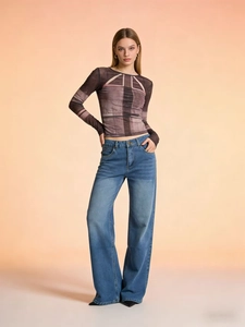 High-waist straight leg jeans with vintage wash paired with a mesh printed long sleeve top