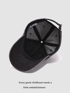 Detailed interior view of washed denim baseball cap with sweatband and adjustable metal buckle