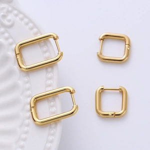 Detail view of geometric 2.5mm gold earrings in rectangular and square shapes