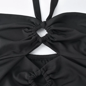Detail of black halter crop top with ruched cutout design and ribbed knit texture