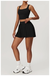 Detail showing high-waisted pleated tennis skirt fabric and textured athletic design