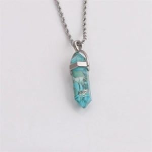 Silver twist chain necklace with a hexagonal turquoise crystal bullet pendant on white background
