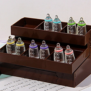 Miniature resin milk bottles in a tiered storage box for DIY craft and dollhouse decor