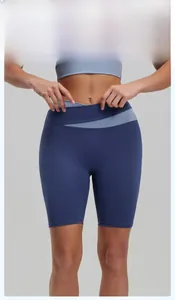 Detail of high waisted biker shorts with blue color blocking and crisscross waist design