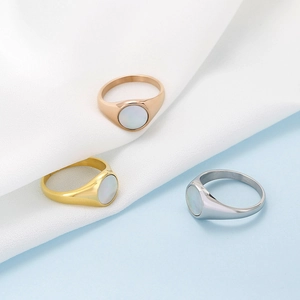 Detail of minimalist signet rings with circular mother-of-pearl in gold and silver finish