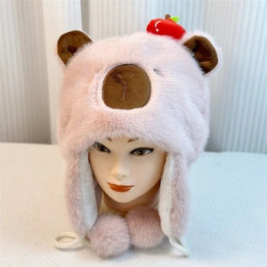 Detail of pink Capybara plush hat featuring cute bear ears and small apple ornament