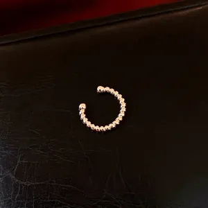 Minimalist gold-plated twisted ear cuff with a polished finish for women