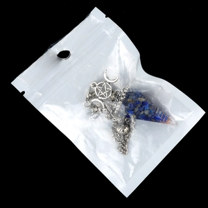 Blue resin hexagonal crystal pendulum necklace with moon and star accents in a clear pouch