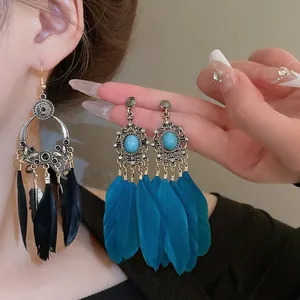 Boucles d'oreilles bohèmes en plumes avec turquoise et gravures ethniques vintage