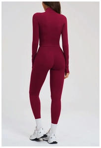 Back view of burgundy yoga set featuring high-waisted leggings and zip-up jacket