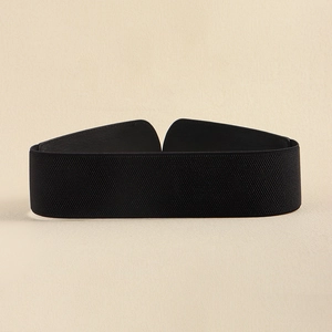 Detail of wide black elastic waist belt with textured fabric and leather ends