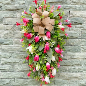 Hanging floral door swag with pink tulips, green leaves and a burlap bow decoration