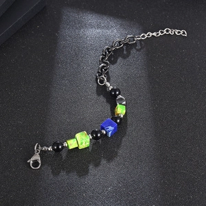 Vintage titanium steel bracelet with black pearls and colored square beads on dark background