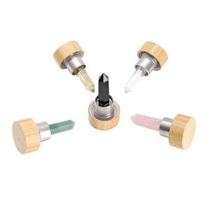 Detail of five natural crystal wands with bamboo lids for energy healing water bottles