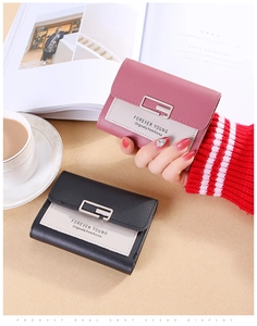 Close-up of contrast color bi-fold wallets with silver metal buckles and logo details