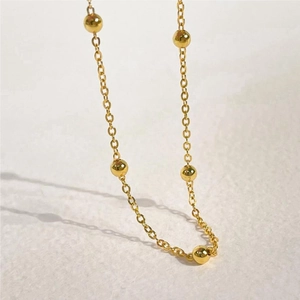 Detailed macro view of golden S925 sterling silver beaded chain with ball accents