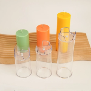 Three sizes of transparent cylindrical candle molds with finished colorful pillar candles
