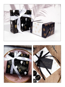 Detail of luxury gift wrapping paper set with balloons patterns and satin ribbons