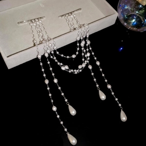 Detailed macro view of elegant pearl tassel hairpins with silver alloy finish