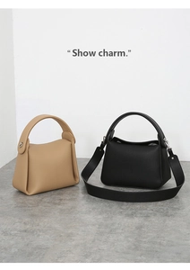 Detailed view of beige and black lychee texture PU leather large capacity handbags